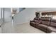 Spacious living room featuring a large brown leather sectional sofa at 4642 Chirping St, North Las Vegas, NV 89031