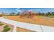 Community playground with climbing structure and play area surrounded by green space and walking path at 4642 Chirping St, North Las Vegas, NV 89031