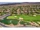 Expansive aerial view showcases the golf course, serene pond, and meticulously planned residential community at 5 Clear Crossing Trl, Henderson, NV 89052