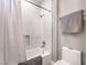 Clean and simple bathroom with a white shower curtain, toilet, and minimalist decor at 5 Clear Crossing Trl, Henderson, NV 89052