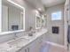 Modern bathroom featuring dual sinks with marble countertops, sleek cabinets, and stylish lighting at 5 Clear Crossing Trl, Henderson, NV 89052