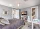 Bedroom with gray walls and wood-look floors featuring a ceiling fan, workspace, and a view to closet at 5 Clear Crossing Trl, Henderson, NV 89052