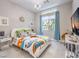Bright bedroom with colorful bedding, ample natural light, and modern decor at 5 Clear Crossing Trl, Henderson, NV 89052