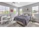 Comfortable bedroom with neutral gray walls, a queen-sized bed, a ceiling fan, and a dedicated workspace at 5 Clear Crossing Trl, Henderson, NV 89052