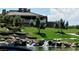 Beautiful clubhouse overlooking a waterfall and a lush green hillside with mature landscaping at 5 Clear Crossing Trl, Henderson, NV 89052