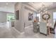 Dining area features unique chairs, modern chandelier, and views into the kitchen at 5 Clear Crossing Trl, Henderson, NV 89052