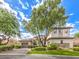 Charming exterior view of a two-story home with mature trees, a well-manicured lawn, and a three-car garage at 5 Clear Crossing Trl, Henderson, NV 89052