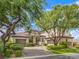 Beautiful home with a well-manicured lawn and lush landscaping, showcasing its curb appeal at 5 Clear Crossing Trl, Henderson, NV 89052