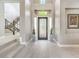 Entrance foyer with a staircase, painting, and a dark front door with sidelights at 5 Clear Crossing Trl, Henderson, NV 89052