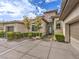 Beautiful front entrance with stone accents, manicured bushes, decorative rocks, and a spacious driveway at 5 Clear Crossing Trl, Henderson, NV 89052