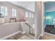 Hallway with views to a bedroom with bold turquoise walls and modern furnishings at 5 Clear Crossing Trl, Henderson, NV 89052