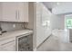 Kitchen with a wine fridge, a sleek countertop, and tall glossy cabinetry for ample storage at 5 Clear Crossing Trl, Henderson, NV 89052