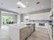 Open kitchen with waterfall island, stainless appliances, skylight, and a dining area at 5 Clear Crossing Trl, Henderson, NV 89052