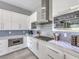 Stylish kitchen with white cabinets, stainless steel appliances, and marble countertops at 5 Clear Crossing Trl, Henderson, NV 89052