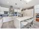 A modern kitchen features sleek cabinetry, a waterfall island, stainless steel appliances, and stylish pendant lighting at 5 Clear Crossing Trl, Henderson, NV 89052