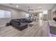 Spacious living room with a large sectional sofa, bar area, and modern entertainment setup at 5 Clear Crossing Trl, Henderson, NV 89052