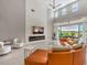 A bright, open-concept living room boasts a high ceiling, modern fireplace and golf course views at 5 Clear Crossing Trl, Henderson, NV 89052