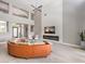 Bright living room with high ceilings, large windows, and an orange, curved sofa at 5 Clear Crossing Trl, Henderson, NV 89052
