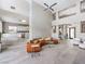 Bright living room with high ceilings, large windows, and an orange, curved sofa at 5 Clear Crossing Trl, Henderson, NV 89052