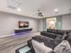 A modern living room features a large black sectional, a media console, and glass sliding doors at 5 Clear Crossing Trl, Henderson, NV 89052