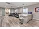 Spacious living area with a bar, seating, media setup, and sliding doors to another room at 5 Clear Crossing Trl, Henderson, NV 89052