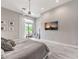 Relax in this serene main bedroom featuring ample natural light, cozy decor, and a large wall-mounted TV at 5 Clear Crossing Trl, Henderson, NV 89052