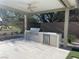 Well-equipped outdoor kitchen with stainless steel grill, beverage fridge, and ample counter space at 5 Clear Crossing Trl, Henderson, NV 89052