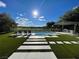A backyard pool is surrounded by lush landscaping and offers picturesque golf course views at 5 Clear Crossing Trl, Henderson, NV 89052