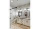 Modern bathroom features marble-style tile, dual sinks, updated fixtures, and a glass-enclosed shower at 5 Red Fawn Ct, Henderson, NV 89074
