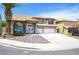 Attractive two-story home boasts a tile roof, a two-car garage, and desert rock landscaping at 5 Red Fawn Ct, Henderson, NV 89074