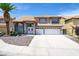 Inviting two-story home with double front doors, two-car garage, and desert rock landscaping at 5 Red Fawn Ct, Henderson, NV 89074