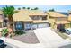 Gorgeous two-story home with tile roofing, two-car garage, and desert rock landscaping at 5 Red Fawn Ct, Henderson, NV 89074