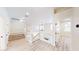 The second floor hallway with a view of the living room and a decorative glass railing at 5 Red Fawn Ct, Henderson, NV 89074