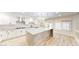 Modern kitchen with white cabinets, island with marble countertop, and stainless steel appliances at 5 Red Fawn Ct, Henderson, NV 89074