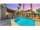 Tranquil backyard pool oasis featuring a rock waterfall, professional landscaping, and outdoor kitchen at 5 Red Fawn Ct, Henderson, NV 89074