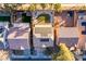 Bird's-eye view of a home with solar panels, a manicured backyard with green space, and lush trees nearby at 5031 Naff Ridge Dr, Las Vegas, NV 89131