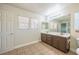Bathroom features double vanity, large mirror, and tile flooring at 5031 Naff Ridge Dr, Las Vegas, NV 89131