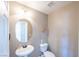 Powder room featuring pedestal sink, soft lighting, and decorative wall art at 5031 Naff Ridge Dr, Las Vegas, NV 89131