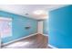 Blue bedroom featuring a window, luxury vinyl plank flooring and a small shelf at 5031 Naff Ridge Dr, Las Vegas, NV 89131