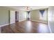 Spacious bedroom featuring wood floors, a ceiling fan, and two windows for natural light at 5031 Naff Ridge Dr, Las Vegas, NV 89131