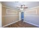 Bedroom with wood floors, ceiling fan, and white trim at 5031 Naff Ridge Dr, Las Vegas, NV 89131