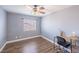 Gray bedroom with ceiling fan, and wood laminate flooring at 5031 Naff Ridge Dr, Las Vegas, NV 89131