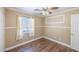 Bedroom features wood floors, fan, window and neutral paint at 5031 Naff Ridge Dr, Las Vegas, NV 89131