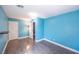 Spacious blue bedroom with laminate floors and bright white trim at 5031 Naff Ridge Dr, Las Vegas, NV 89131
