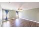 Primary bedroom features wood floors, a ceiling fan, and natural light from two windows at 5031 Naff Ridge Dr, Las Vegas, NV 89131