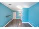 A bright blue bedroom with wood floors, a small table, and white trim at 5031 Naff Ridge Dr, Las Vegas, NV 89131