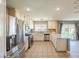 Traditional style kitchen features stainless steel appliances, light cabinets and tile flooring at 5031 Naff Ridge Dr, Las Vegas, NV 89131