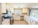 Spacious kitchen features stainless steel appliances, white cabinets and light countertops at 5031 Naff Ridge Dr, Las Vegas, NV 89131