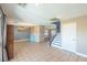 Open-concept living space with tile, access to the backyard, stairs, and a chandelier at 5031 Naff Ridge Dr, Las Vegas, NV 89131