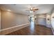 Inviting living room with wood floors, a ceiling fan, built-in shelving, and a staircase at 5031 Naff Ridge Dr, Las Vegas, NV 89131